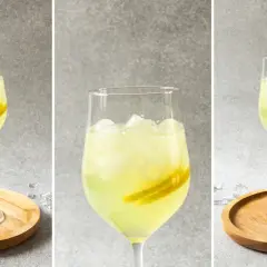 Orzeźwiający drink z limoncello, lodem i plasterkami cytryny, podany na drewnianej podstawce. Idealny na letnie popołudnie.