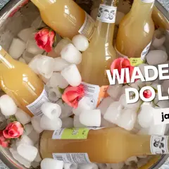 Butelki z napojem w wiaderku do lodu, ozdobione różami. Idealne na upalne dni.